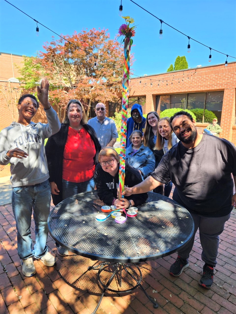 group of people posed around a table smiling